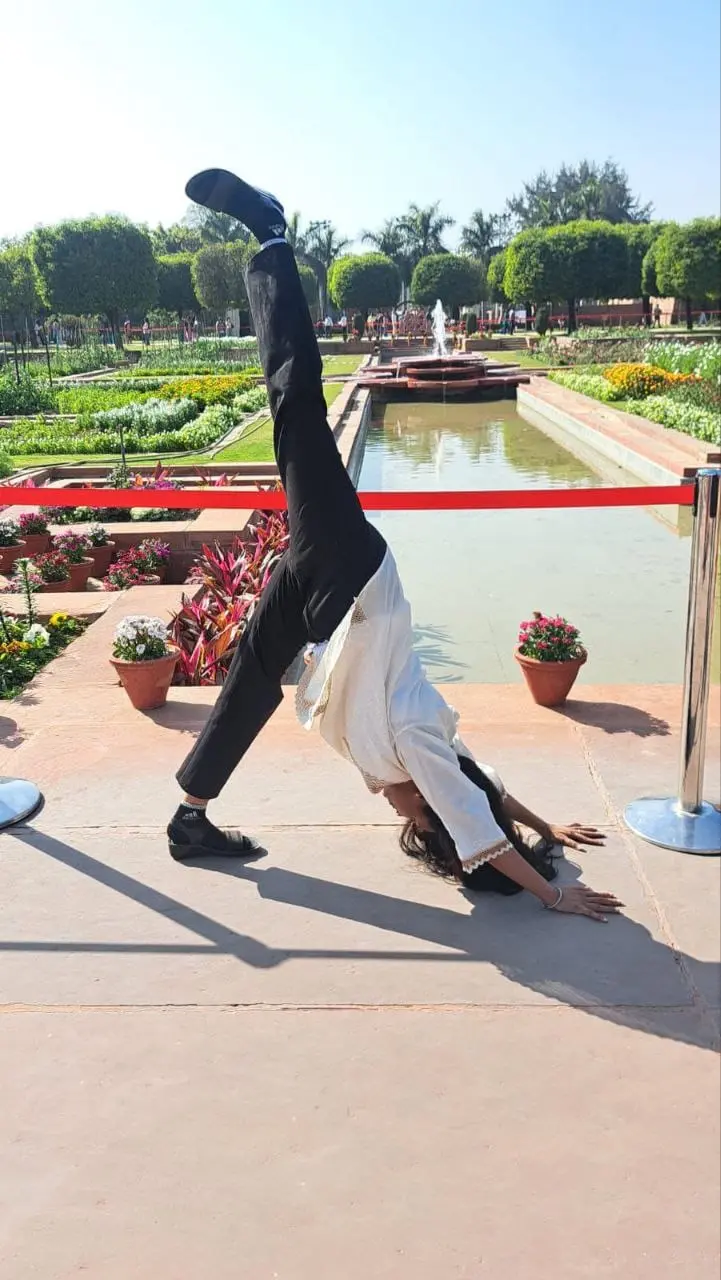 Yoga instructor helping client with posture